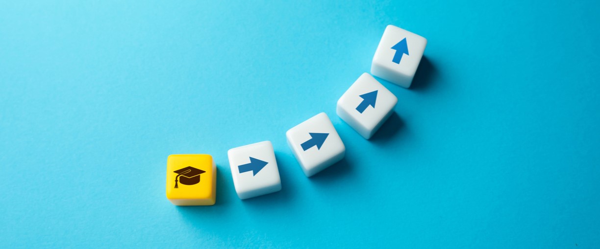 Concept of transition and moving up to secondary school shown with a graduation cap and arrows